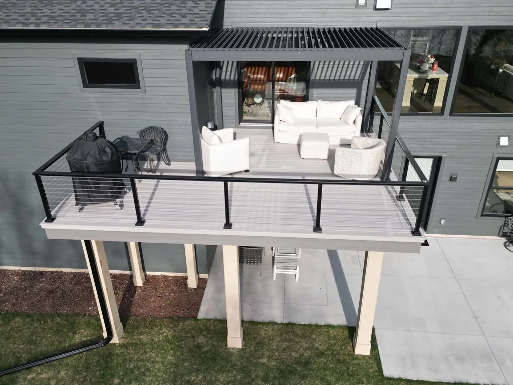 Light gray composite deck with black metal railings