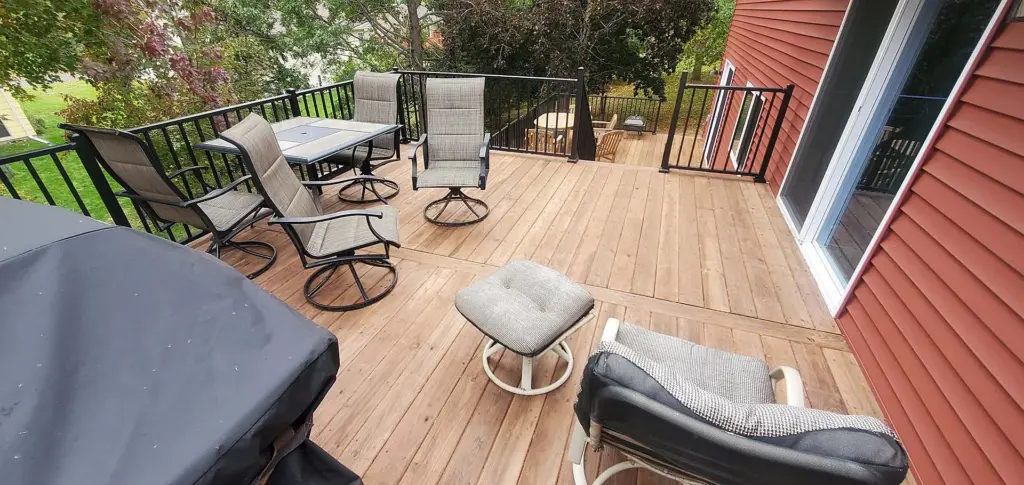 perspective-view-of-the-outdoor-living-area-space-with-black-metal-railing-attached-on-red-modern-house-in-twin-cities-mn